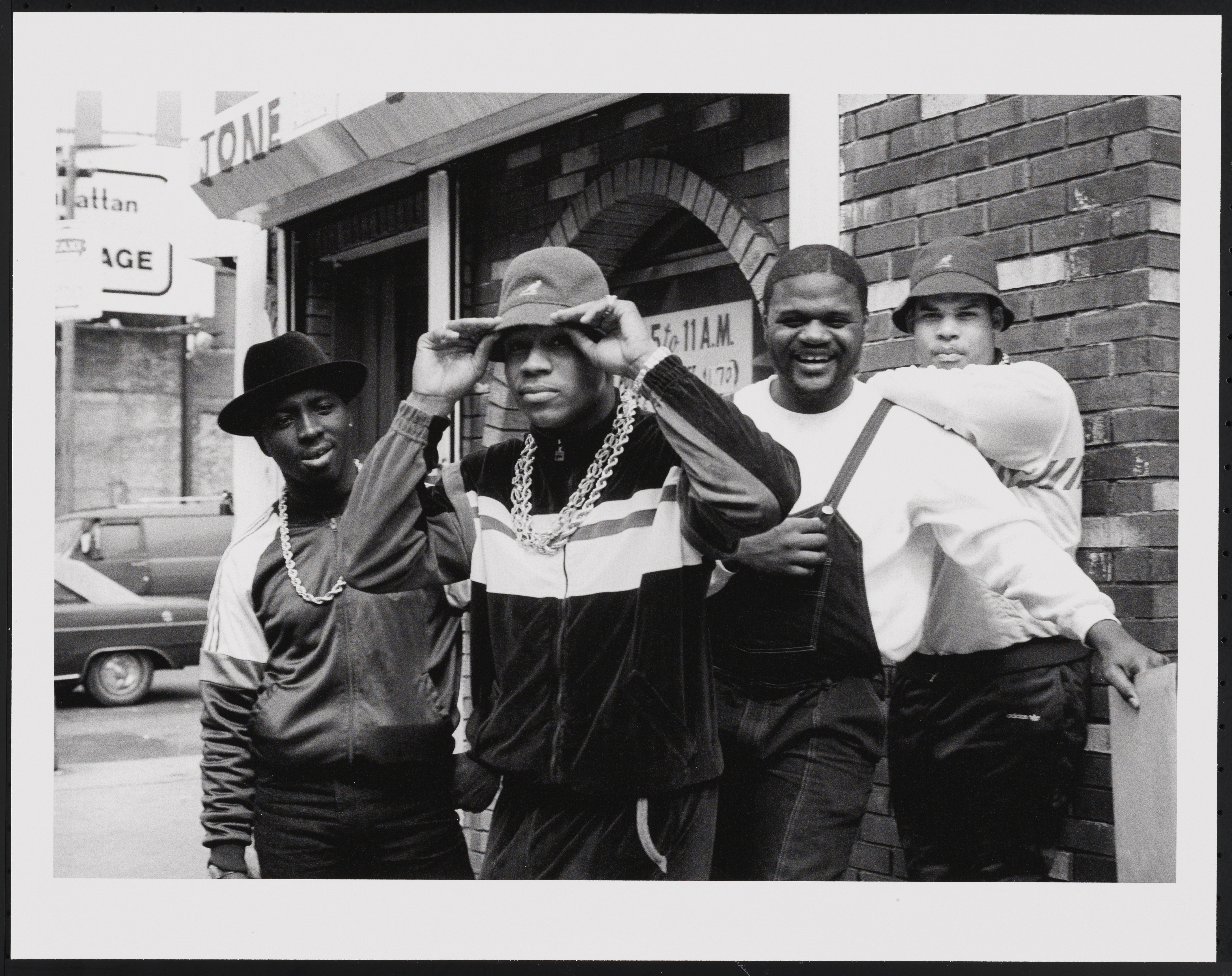 An Image of Image: a black and white image of LL Cool J with Cut Creator, E-Love, and B-Rock